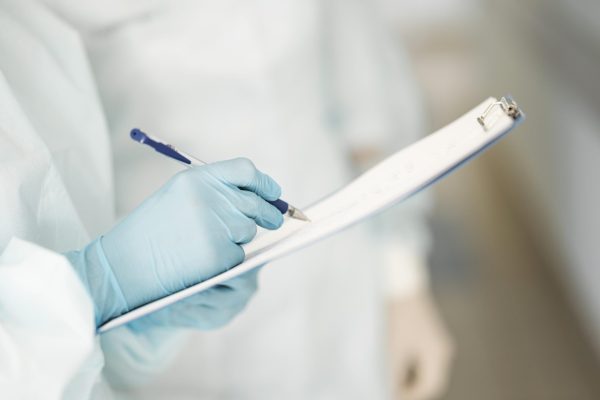 close-up-doctors-completing-medical-form